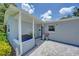 Inviting front porch with seating area, decorative planters, and stylish tile flooring at 5044 17Th N St, St Petersburg, FL 33714