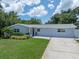 Charming single-story home with well-manicured lawn and freshly painted exterior under a blue sky at 5044 17Th N St, St Petersburg, FL 33714