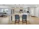 Spacious open-concept with kitchen island seating next to open living room and dining area at 5044 17Th N St, St Petersburg, FL 33714