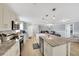 Open-concept kitchen with an island and modern appliances next to open living and dining area at 5044 17Th N St, St Petersburg, FL 33714
