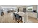 Open kitchen with island seating, stainless appliances, seamlessly flowing to living room at 5044 17Th N St, St Petersburg, FL 33714