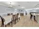 Open-concept layout combines a dining and living area, featuring modern decor, wood floors, and natural light at 5044 17Th N St, St Petersburg, FL 33714