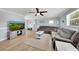 Cozy living room with a sectional sofa, a TV, natural light, and neutral paint at 5044 17Th N St, St Petersburg, FL 33714
