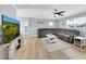 Comfortable living room featuring a large sectional sofa, flat screen TV, and neutral decor at 5044 17Th N St, St Petersburg, FL 33714