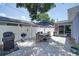 Charming outdoor patio with a dining set, grill, and fenced yard perfect for entertaining and relaxation at 5044 17Th N St, St Petersburg, FL 33714