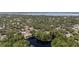 An aerial view of a beautiful lake surrounded by lush trees and homes at 506 Duxbury Ct # A, Safety Harbor, FL 34695
