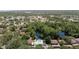 Aerial view of community featuring a pool, pond, and surrounded by lush greenery and residences at 506 Duxbury Ct # A, Safety Harbor, FL 34695