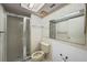 Bathroom featuring a glass door shower, toilet, and vanity with a mirror at 506 Duxbury Ct # A, Safety Harbor, FL 34695