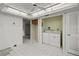 This spacious laundry room features a washer and dryer and white tile floors at 506 Duxbury Ct # A, Safety Harbor, FL 34695