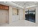 Laundry room features tile flooring, side-by-side washer and dryer, with a glass sliding door to the outside at 506 Duxbury Ct # A, Safety Harbor, FL 34695