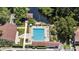 An aerial shot showcasing a pristine community pool with lounge chairs and lush greenery at 506 Duxbury Ct # A, Safety Harbor, FL 34695