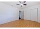 An empty bedroom features a ceiling fan, wood floors, and a closet with sliding doors at 5221 4Th N Ave, St Petersburg, FL 33710