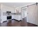 Beautiful kitchen showcasing white cabinets, modern appliances and a large barn door to the hallway at 5221 4Th N Ave, St Petersburg, FL 33710