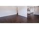 Open-concept living space featuring hardwood floors, freshly painted white walls and barn door to hall at 5221 4Th N Ave, St Petersburg, FL 33710