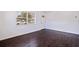 This inviting living room offers hardwood floors, freshly painted white walls and a bright and welcoming atmosphere at 5221 4Th N Ave, St Petersburg, FL 33710