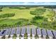 Aerial view of a community of single-Gathering homes, a vast field, and forested area at 6019 Shorebird Br, Land O Lakes, FL 34638