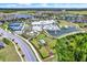 A high-angle view featuring a clubhouse, community pool, tennis courts, and dog park at 6019 Shorebird Br, Land O Lakes, FL 34638
