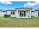 Exterior view of the back of the home featuring a covered patio and spacious backyard at 6019 Shorebird Br, Land O Lakes, FL 34638