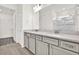Modern bathroom featuring a double vanity, large mirror, and glass-enclosed shower at 6019 Shorebird Br, Land O Lakes, FL 34638