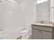 Bathroom featuring a vanity, toilet, bathtub, and shower with white tiling at 6019 Shorebird Br, Land O Lakes, FL 34638
