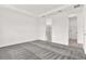 Bright bedroom with gray carpet, ensuite bathroom with glass-enclosed shower, and walk-in closet at 6019 Shorebird Br, Land O Lakes, FL 34638