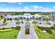 A beautiful clubhouse stands with palm trees, lush landscaping, and ample parking at 6019 Shorebird Br, Land O Lakes, FL 34638