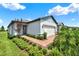 Charming single Gathering home with a two car garage, brick driveway, and manicured landscaping at 6019 Shorebird Br, Land O Lakes, FL 34638