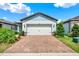 Charming single-story home featuring a brick driveway and a two-car garage at 6019 Shorebird Br, Land O Lakes, FL 34638