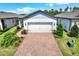 Charming single Gathering home with a two car garage and a brick driveway at 6019 Shorebird Br, Land O Lakes, FL 34638