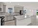 Stylish kitchen featuring granite countertops, stainless steel appliances, and island at 6019 Shorebird Br, Land O Lakes, FL 34638