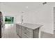 Modern kitchen island with granite countertop, drawers, and an open layout at 6019 Shorebird Br, Land O Lakes, FL 34638