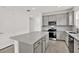 Modern kitchen with gray cabinets, stainless steel appliances, and a large island at 6019 Shorebird Br, Land O Lakes, FL 34638