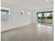 Spacious living room with tile floors and sliding glass doors to the backyard at 6019 Shorebird Br, Land O Lakes, FL 34638