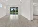 Open-concept living room with tile floors and a view to the backyard at 6019 Shorebird Br, Land O Lakes, FL 34638