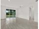 Bright living room featuring tile floors, recessed lighting and access to the backyard at 6019 Shorebird Br, Land O Lakes, FL 34638
