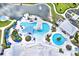 Aerial view of a modern pool area with multiple pools, a bar, and ample seating at 6019 Shorebird Br, Land O Lakes, FL 34638