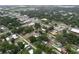 High aerial view of the town featuring tree-lined streets, residential houses, and nearby buildings at 606 N Merrin St, Plant City, FL 33563