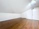 Attic space with hardwood floors, sloped ceiling, and white walls at 606 N Merrin St, Plant City, FL 33563