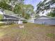Backyard view of the home with a brick fire pit and a detached garage at 606 N Merrin St, Plant City, FL 33563