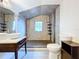 Modern bathroom featuring a walk-in shower, vessel sink, tiled walls, and a modern toilet at 606 N Merrin St, Plant City, FL 33563