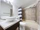 Updated bathroom with stylish fixtures, vanity sink, and tiled shower at 606 N Merrin St, Plant City, FL 33563
