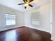 Bedroom featuring ceiling fan, hardwood floors, and natural light at 606 N Merrin St, Plant City, FL 33563