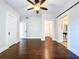 Spacious bedroom featuring hardwood floors, ceiling fan, and access to the closet and bathroom at 606 N Merrin St, Plant City, FL 33563