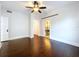 This bedroom features hardwood floors, ample space, and convenient access to a private bathroom at 606 N Merrin St, Plant City, FL 33563