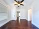 Bright bedroom with hardwood floors, ceiling fan, and white trim at 606 N Merrin St, Plant City, FL 33563