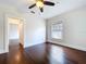 Cozy bedroom featuring hardwood floors, a window, and white trim at 606 N Merrin St, Plant City, FL 33563
