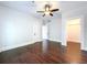 Large bedroom with hardwood floors, white trim, ceiling fan, and ample natural light at 606 N Merrin St, Plant City, FL 33563