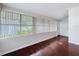 Dining room features large windows with blinds and hardwood floors at 606 N Merrin St, Plant City, FL 33563