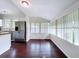 Dining Room featuring large windows with blinds and gleaming hardwood floors at 606 N Merrin St, Plant City, FL 33563