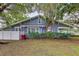 Charming single-story home featuring a well-maintained lawn, shrubbery and a light blue exterior paint at 606 N Merrin St, Plant City, FL 33563